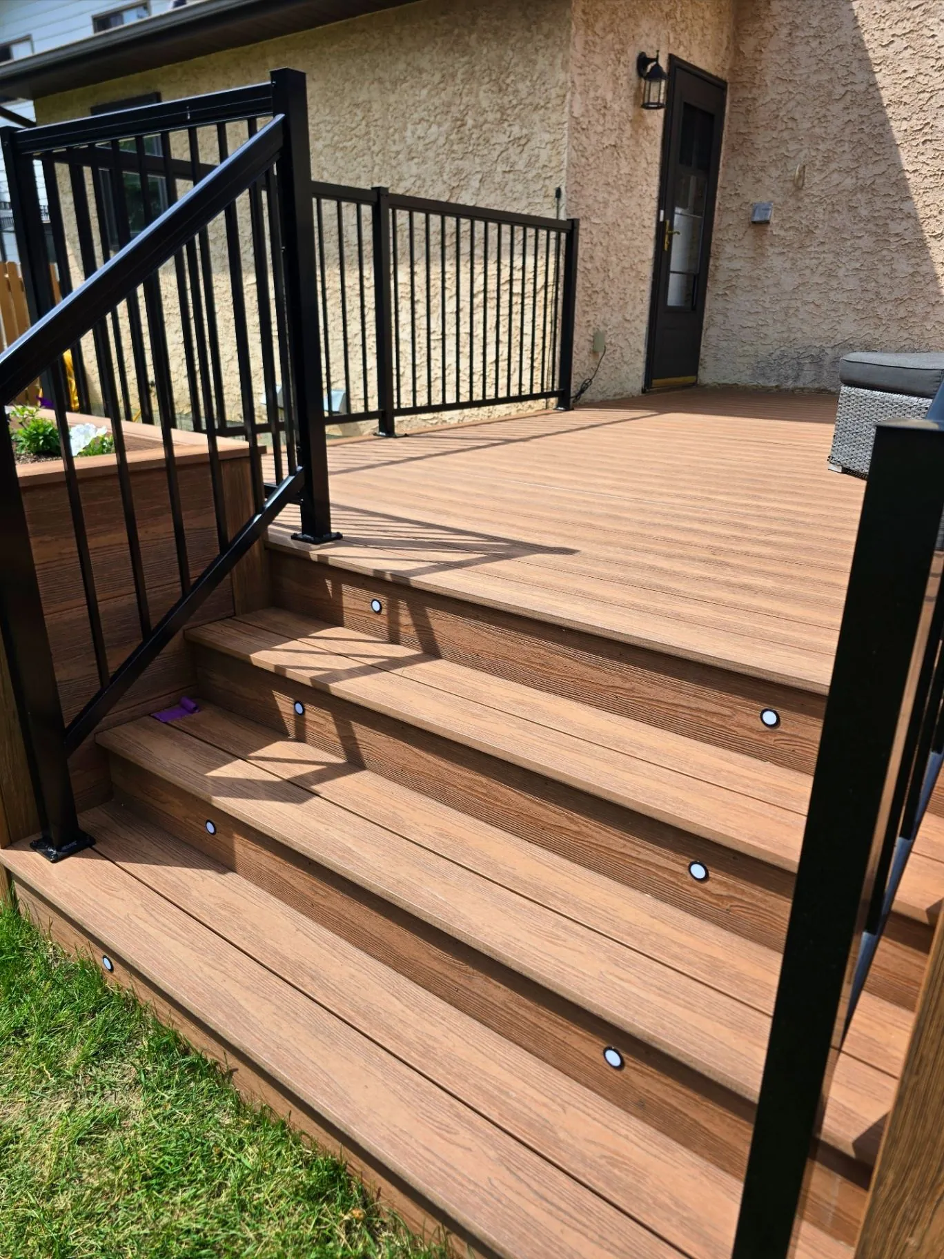Eva-Last composite deck with planters & stair lighting — photo 7